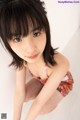 A young woman in a colorful bathing suit posing for a picture.