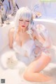 A woman sitting in a bathtub covered in foam.