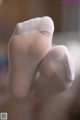 A close up of a person's feet in white socks.