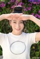 A woman in a white shirt is posing for a picture.