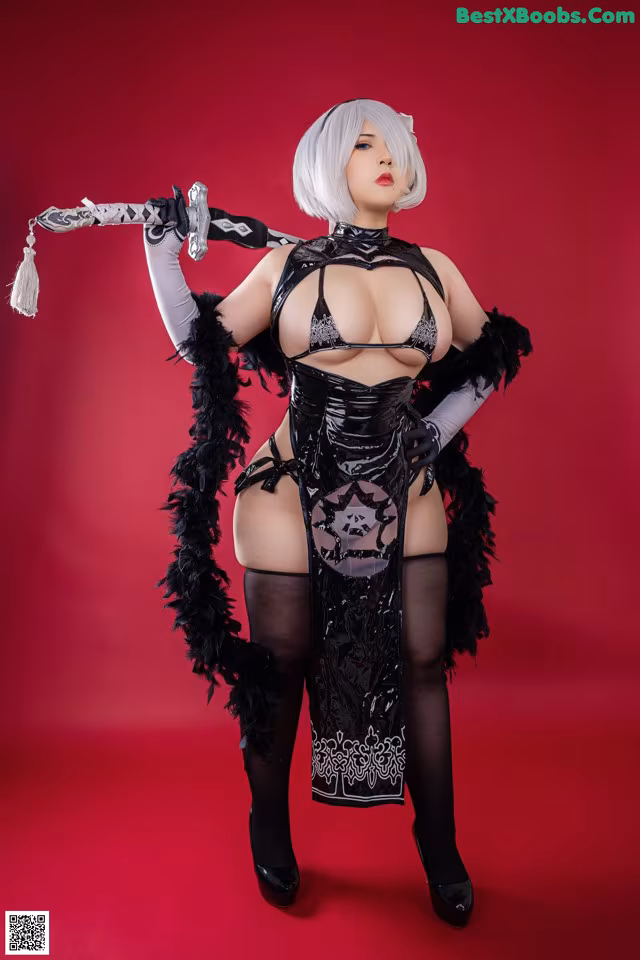 A woman in a black and white outfit holding a sword.