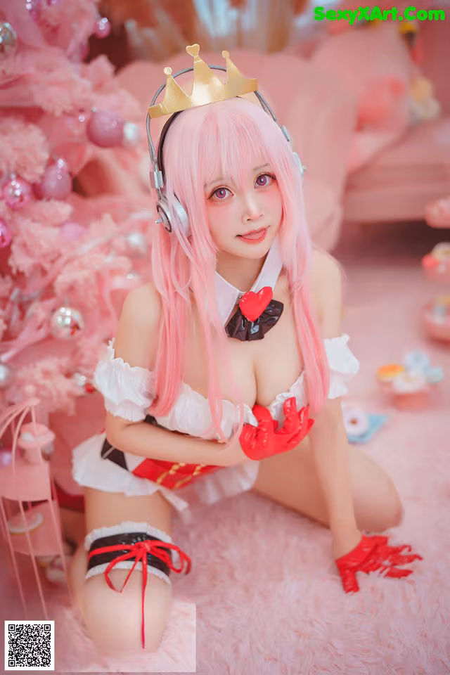A woman with pink hair wearing a crown and headphones.